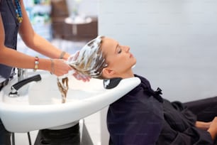 a woman getting her hair washed in a salon