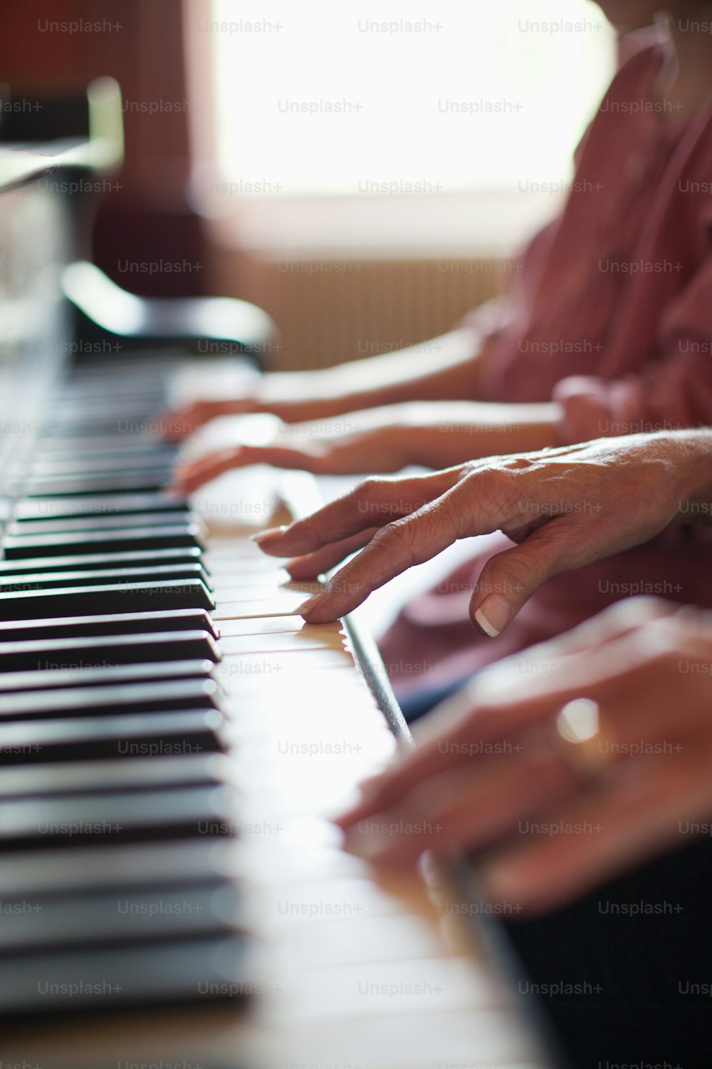 a woman is playing a piano with her hands