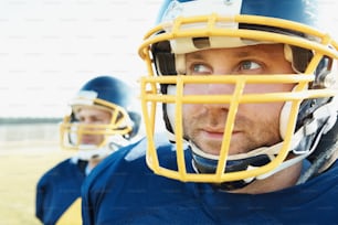 Closeup of American football players with helmets outdoors