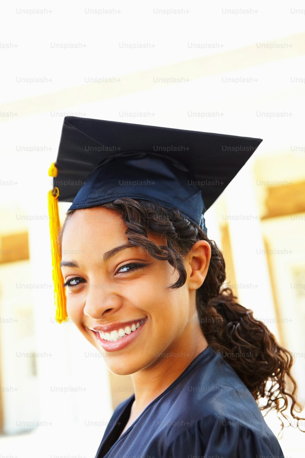 Closeup of smiling young girl in an academic gown