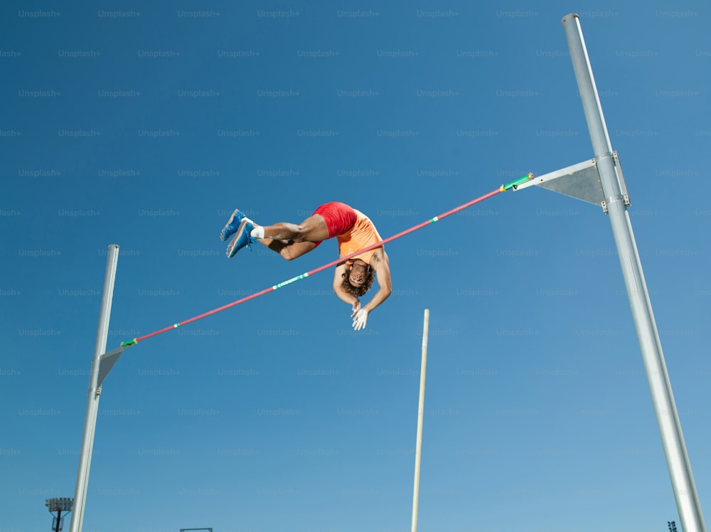 a man is high in the air on a high jump
