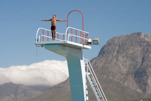 a man standing on top of a life guard tower