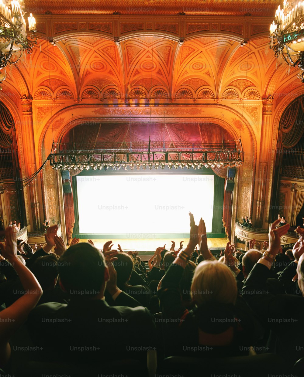 a crowd of people sitting in front of a stage