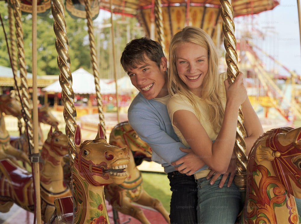 a man and a woman hugging on a merry go round