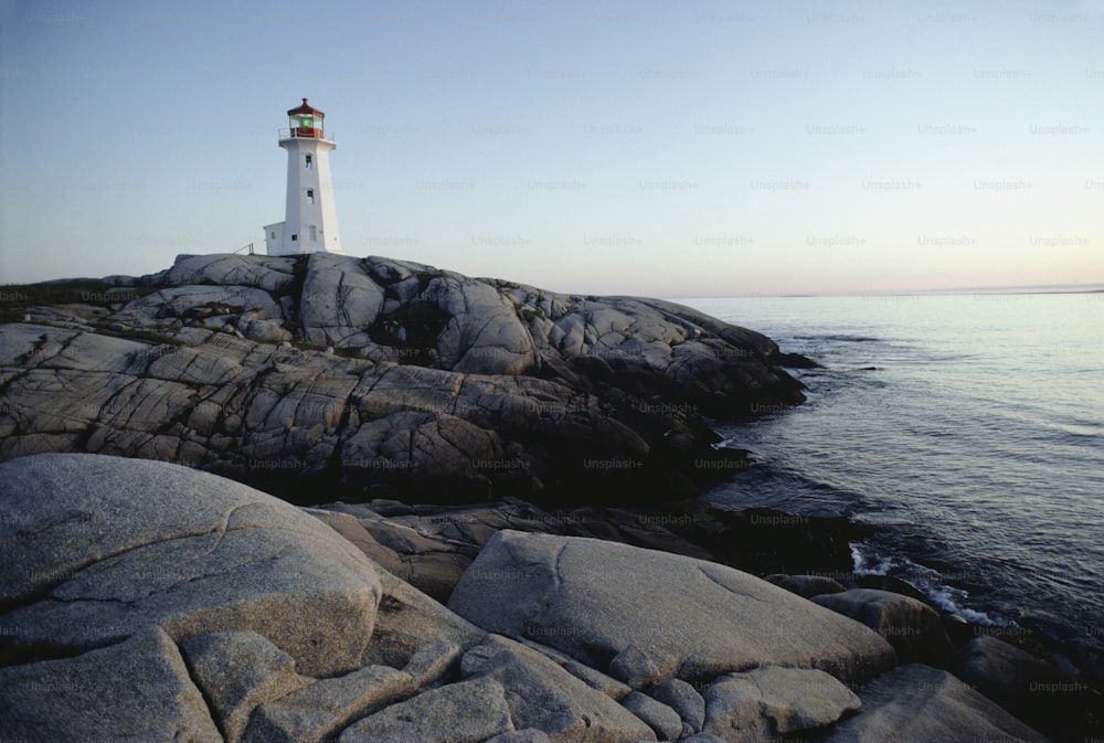 a light house sitting on top of a rocky shore