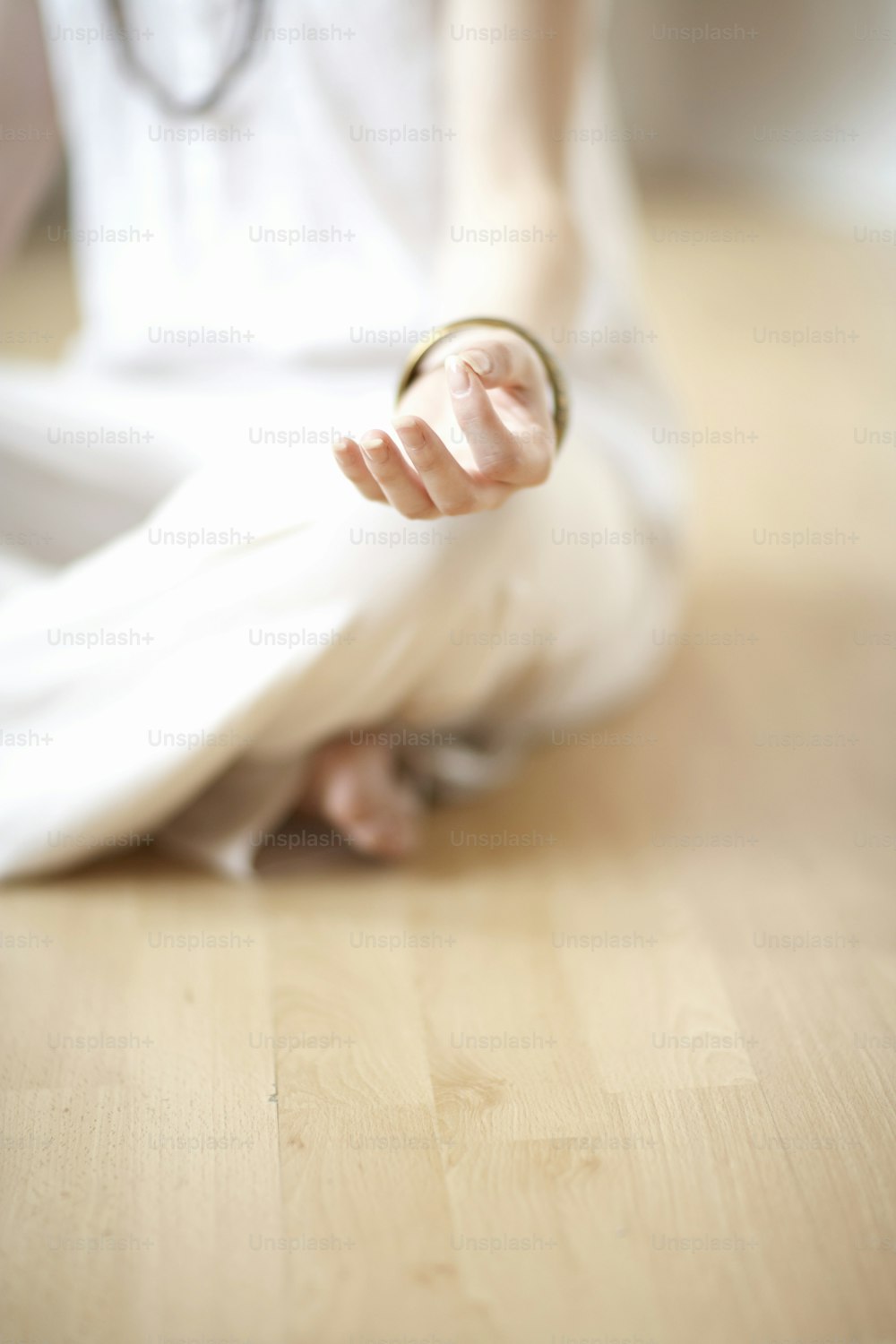 a person sitting on the floor with a ring in their hand
