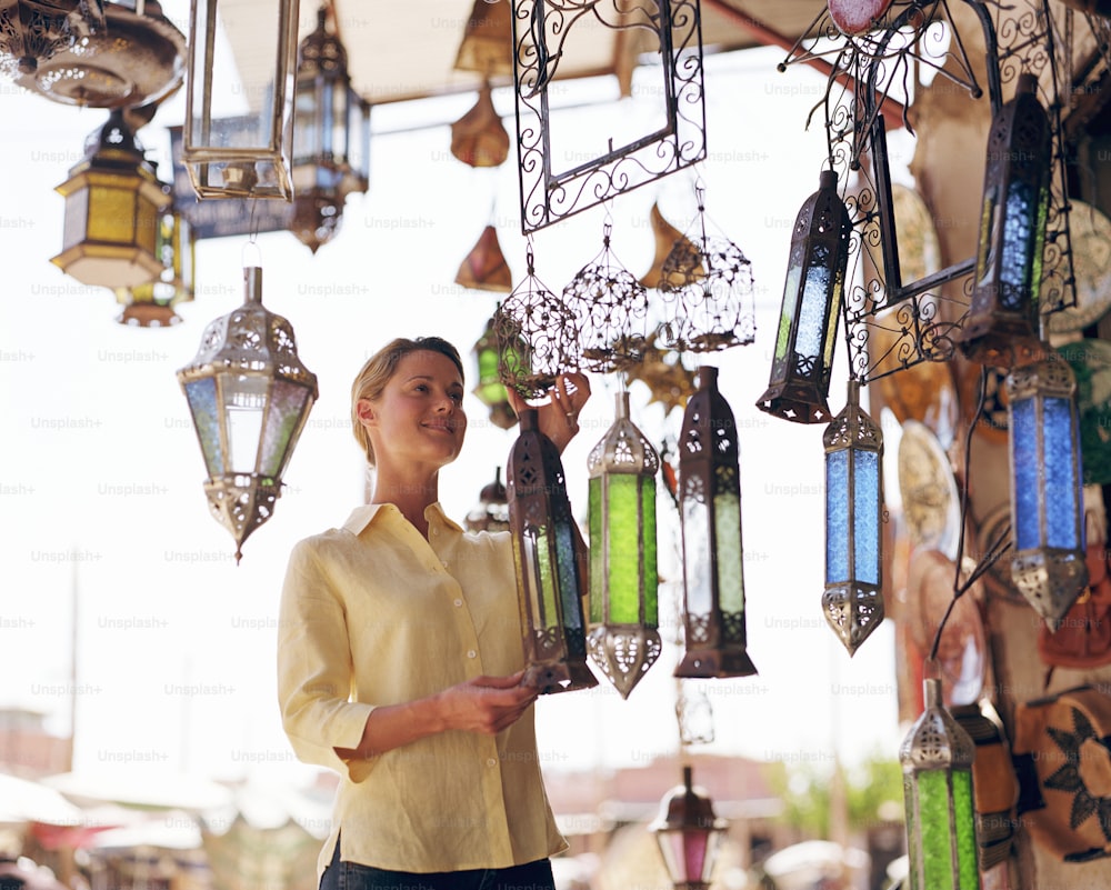 Una mujer sosteniendo una linterna en un mercado