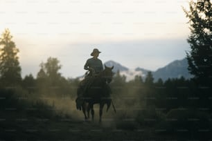 a man riding on the back of a brown horse