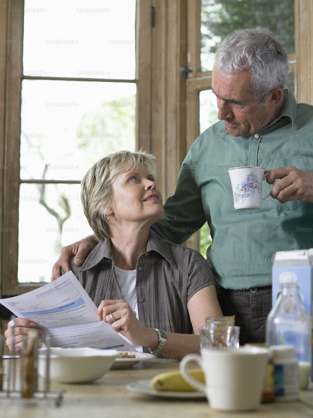 a man standing next to a woman at a table