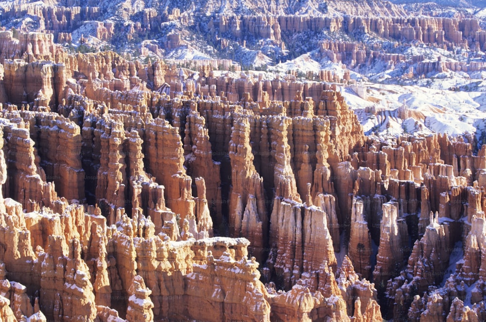 a large group of rock formations covered in snow