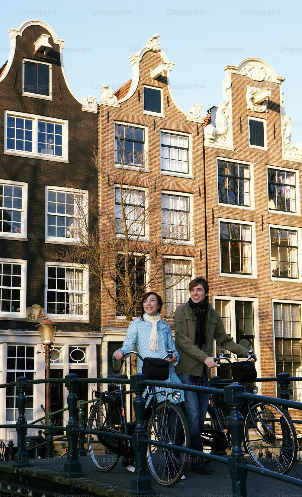 a man and a woman standing next to bicycles