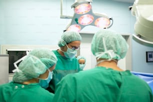 a group of doctors in scrubs in a operating room