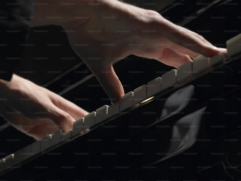 a person playing a piano with their hands