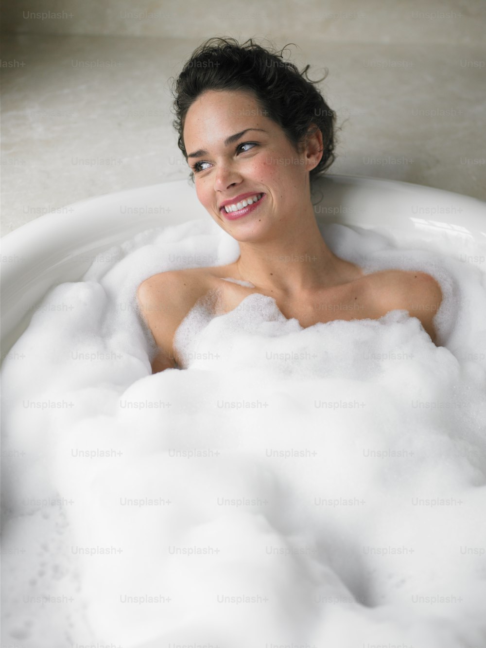 a woman in a bathtub full of foam
