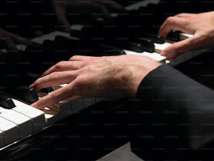 a person playing a piano with their hands