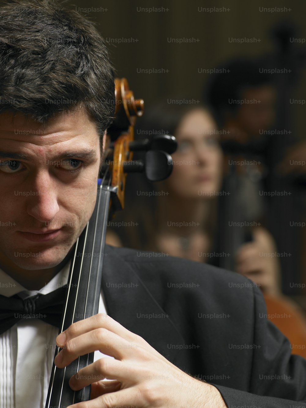 a man in a tuxedo holding a violin