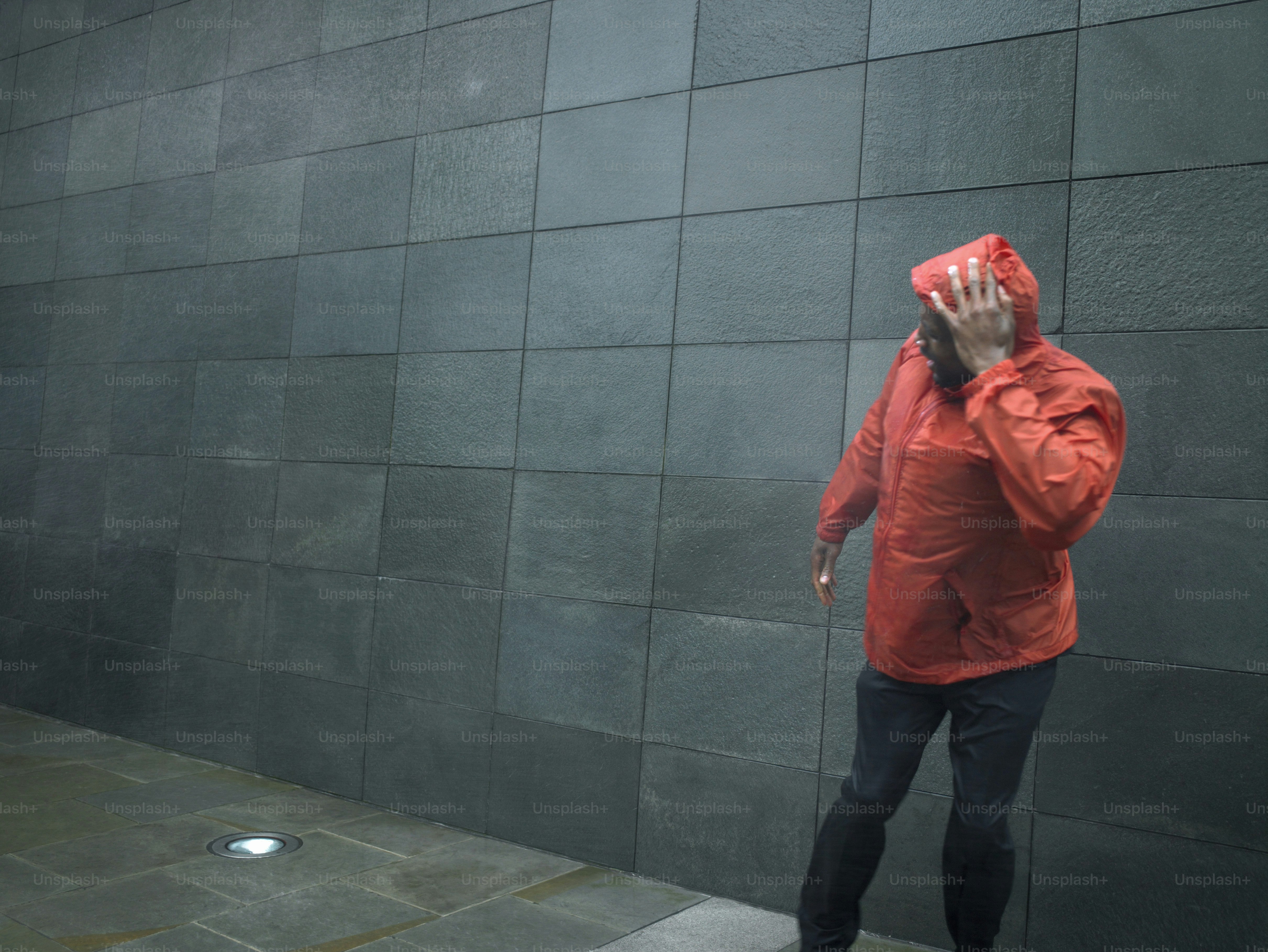 a man in a red jacket talking on a cell phone