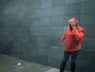 a man in a red jacket talking on a cell phone