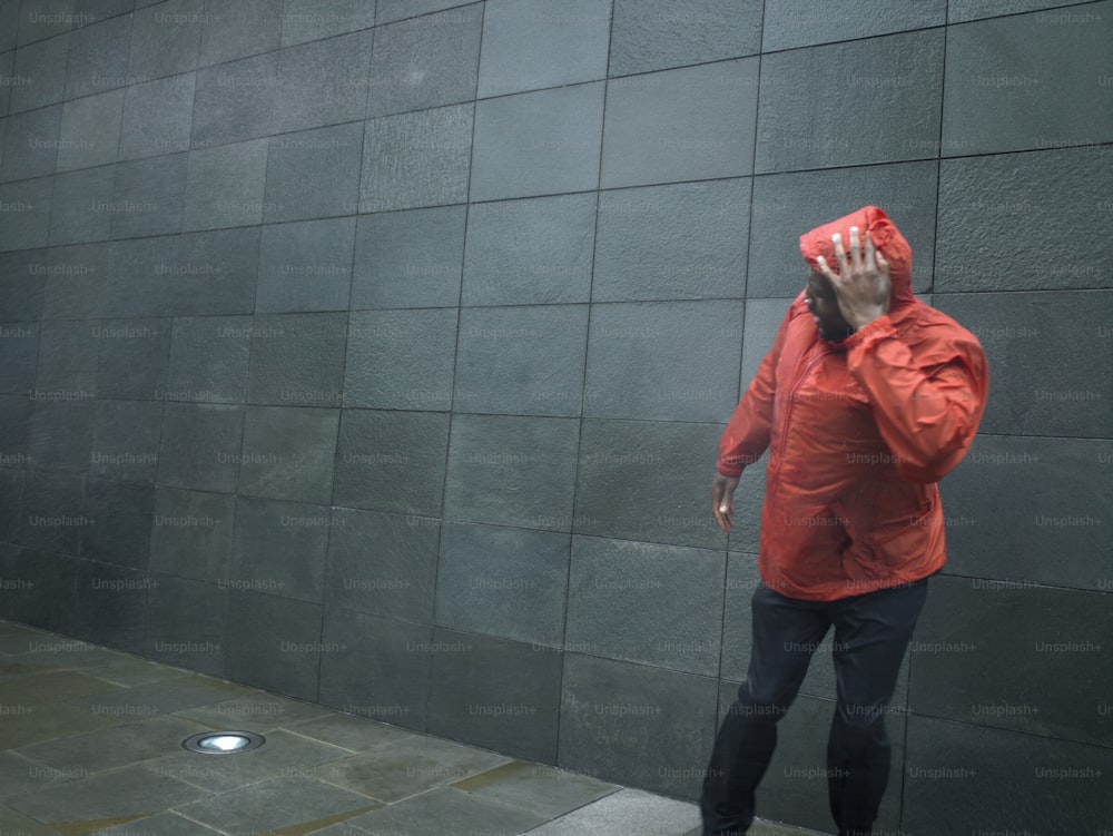 a man in a red jacket talking on a cell phone