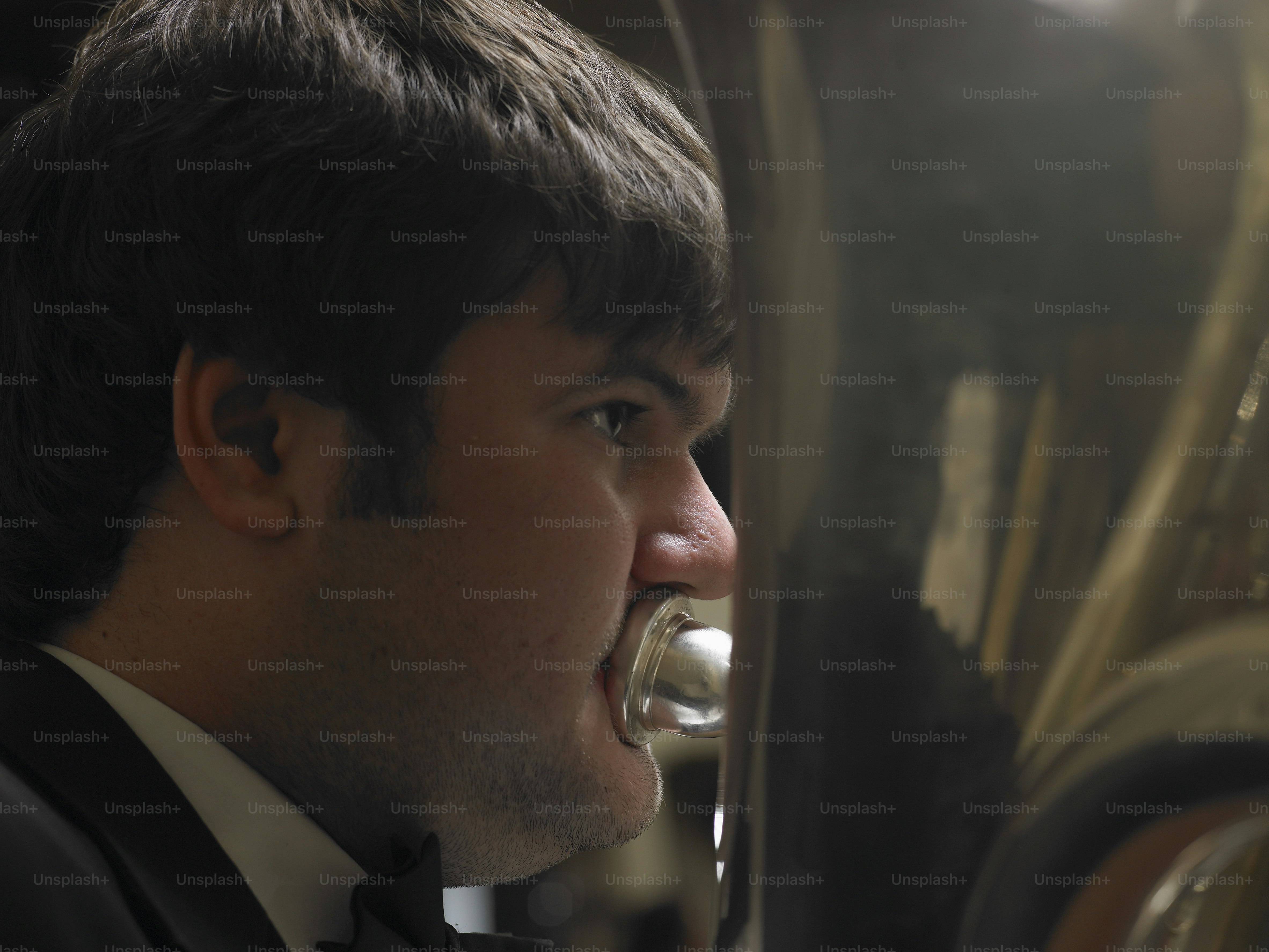 a man in a tuxedo drinking from a wine glass