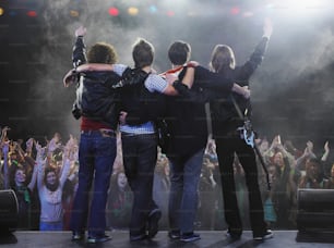 a group of people standing on top of a stage