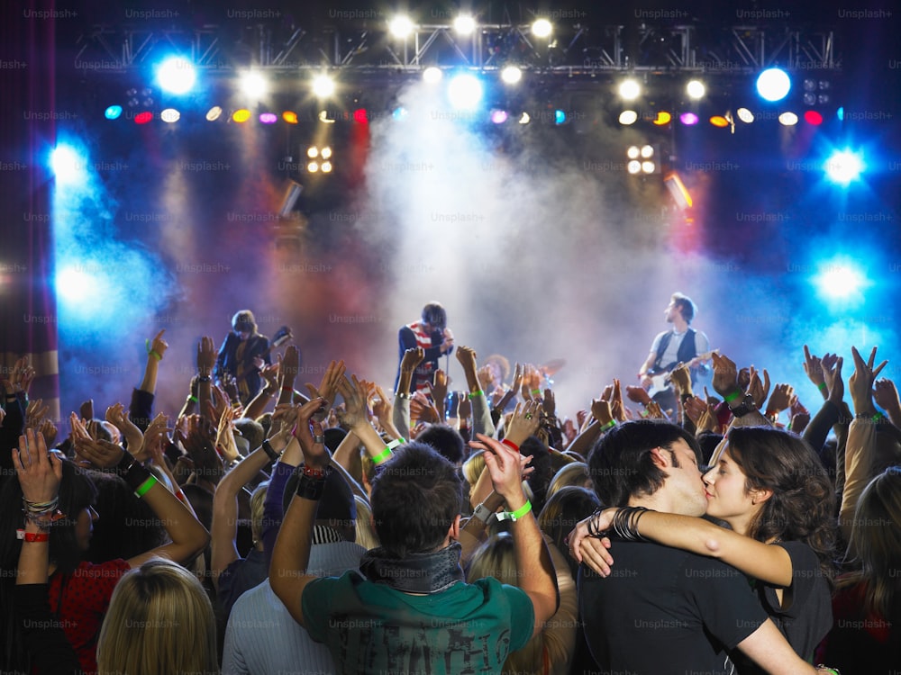 a couple of people that are standing in front of a crowd