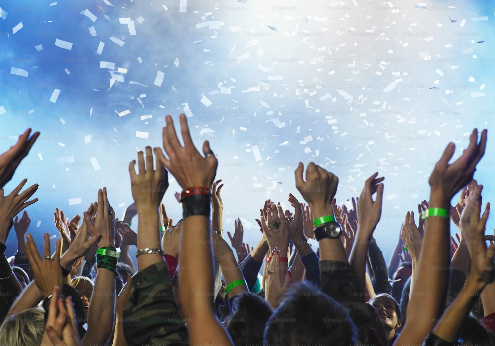 Supporters raising their hands together at a campaign rally