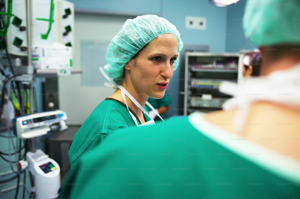a woman in scrubs in a hospital operating room