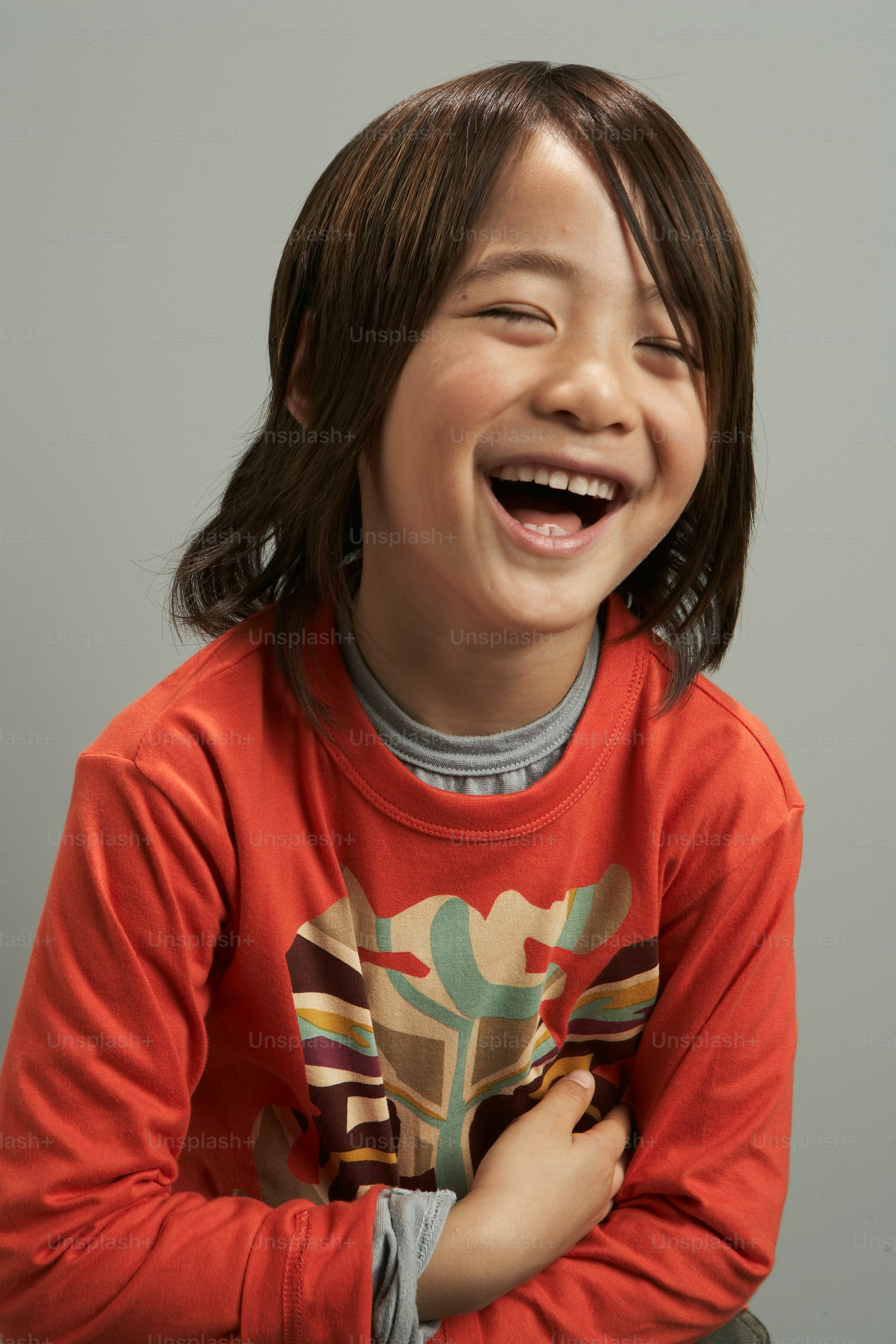 A young girl smiling and holding her hands together photo – Waist up ...