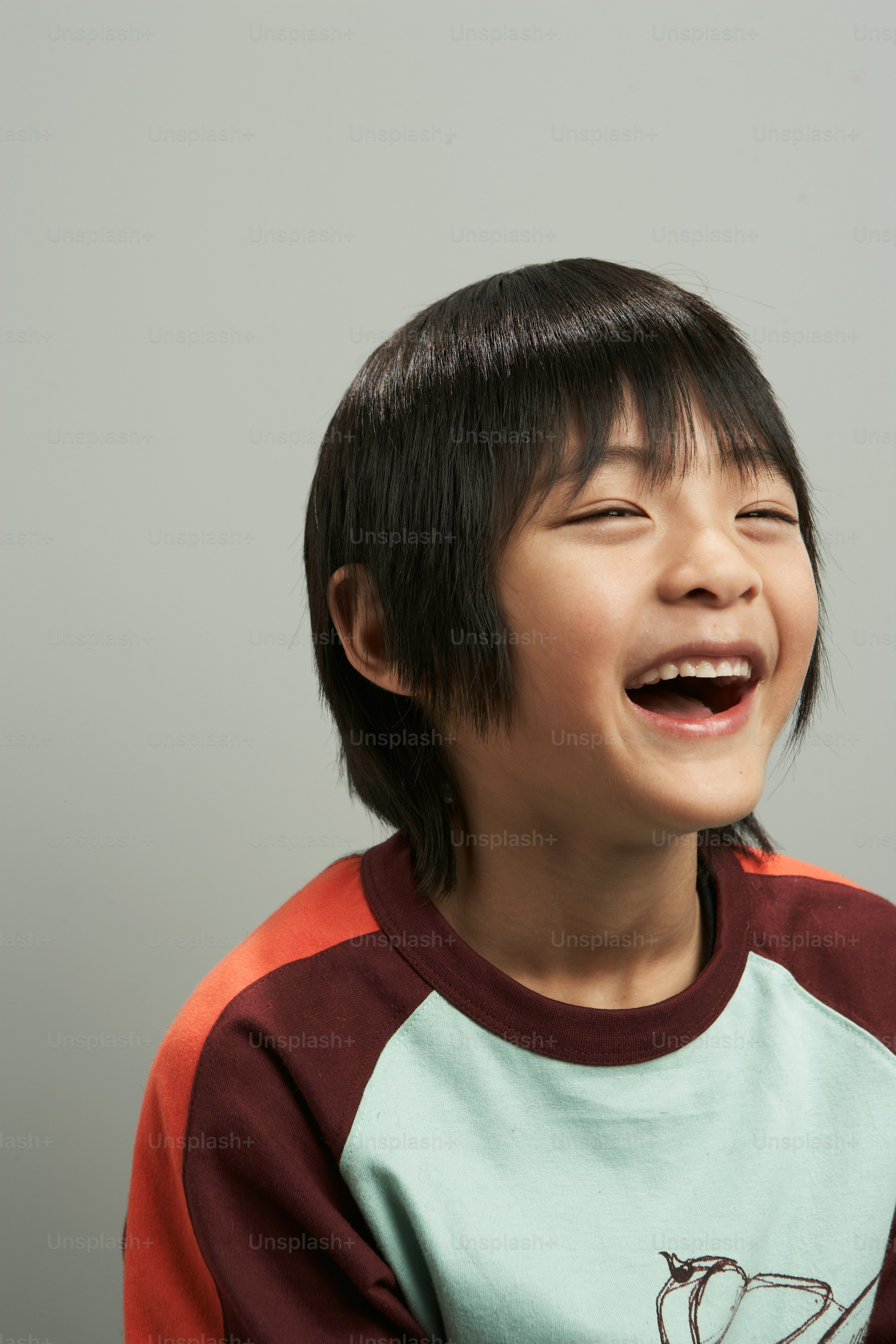 a young boy with a toothbrush in his mouth