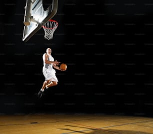 a man jumping up into the air to dunk a basketball