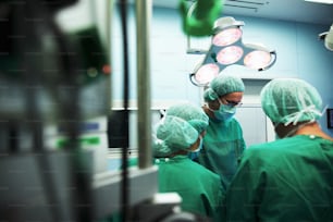 a group of surgeons in a operating room