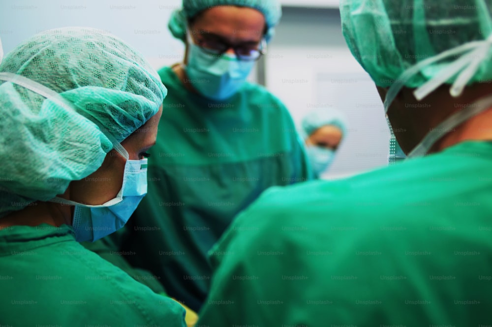 a group of surgeons in green scrubs and masks
