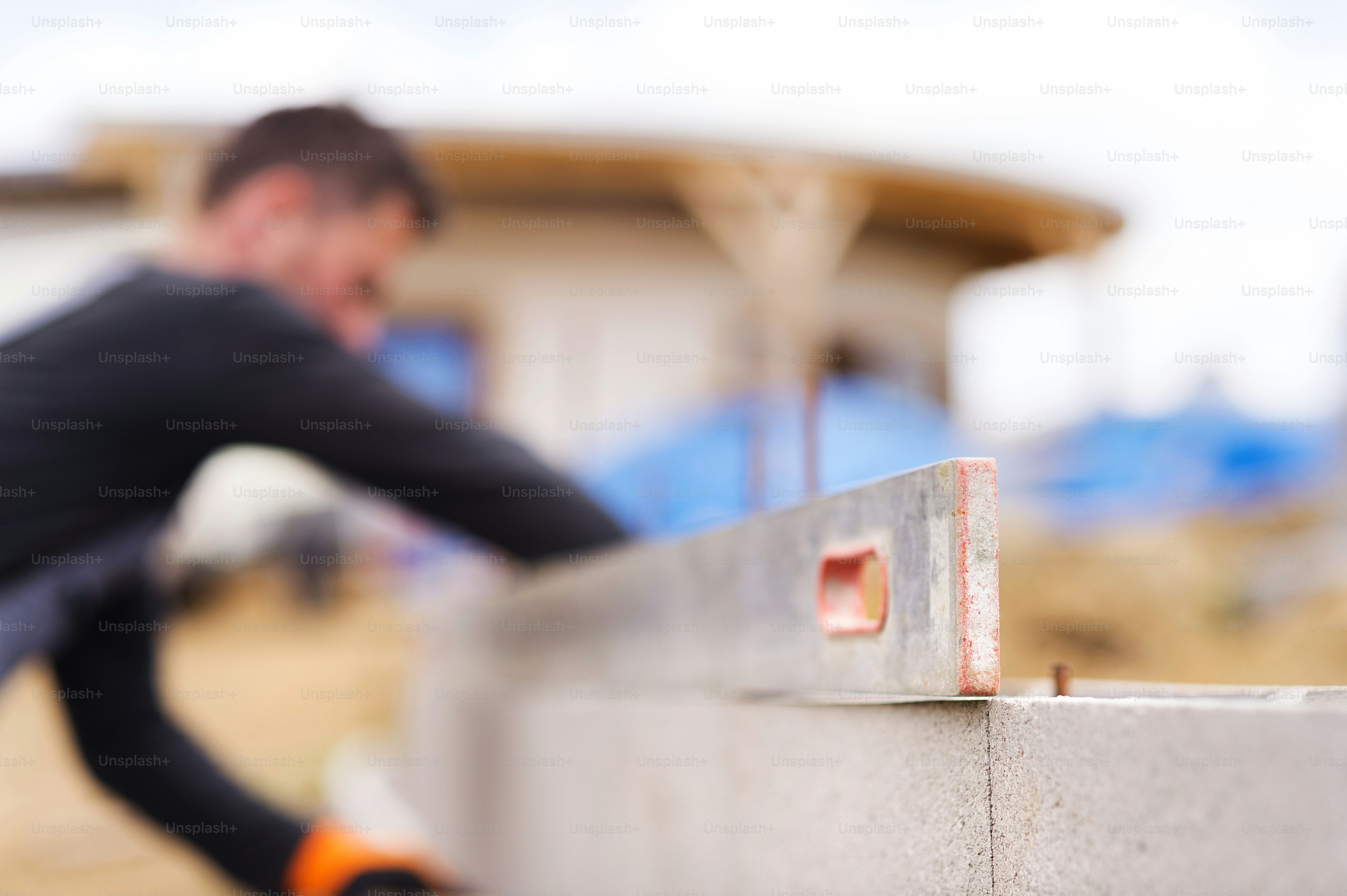 Bricklayer putting down another row of bricks in site photo – Labour ...