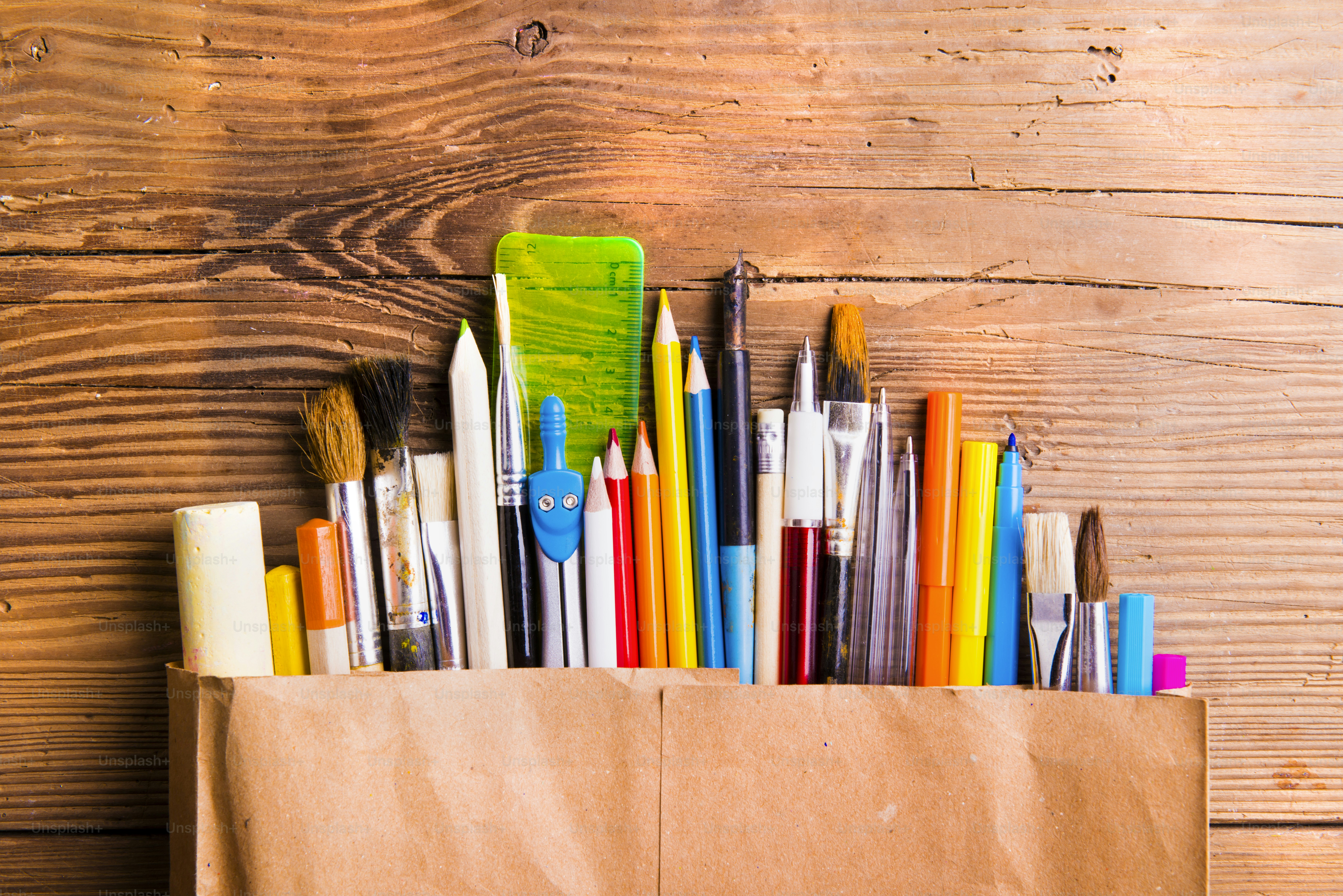 Desk with stationary. Studio shot on wooden background. photo Back to