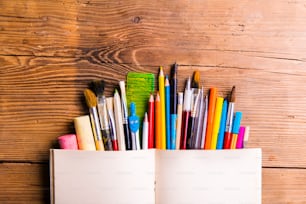 Desk with stationary. Studio shot on wooden background.