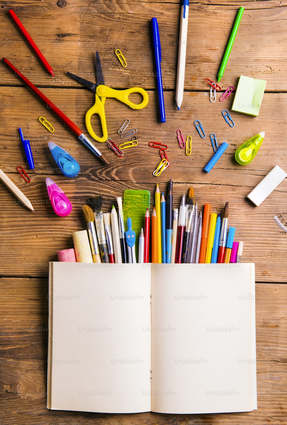 Desk with stationary. Studio shot on wooden background.