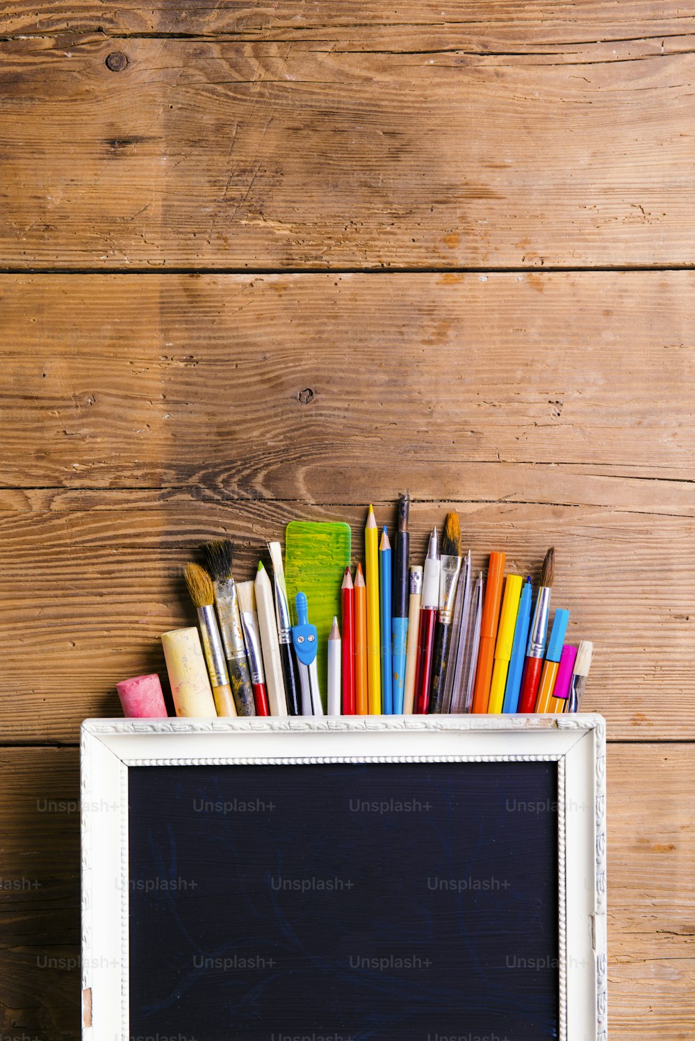 Desk with stationary. Studio shot on wooden background.