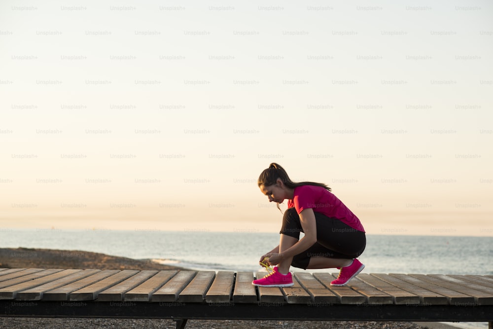 Running woman. Female runner jogging during outdoor workout on beach.