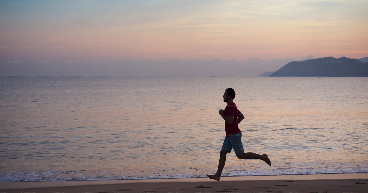 Active Man Running Silhouette of sport active man running and exercising on the beach at ...