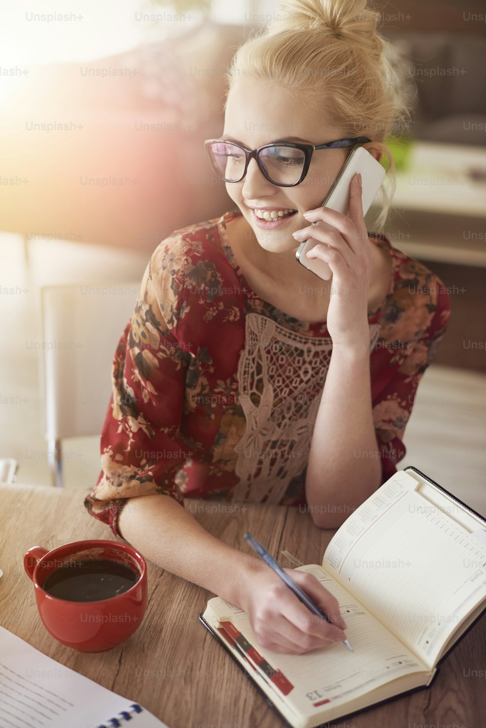 Cheerful woman using her organizer