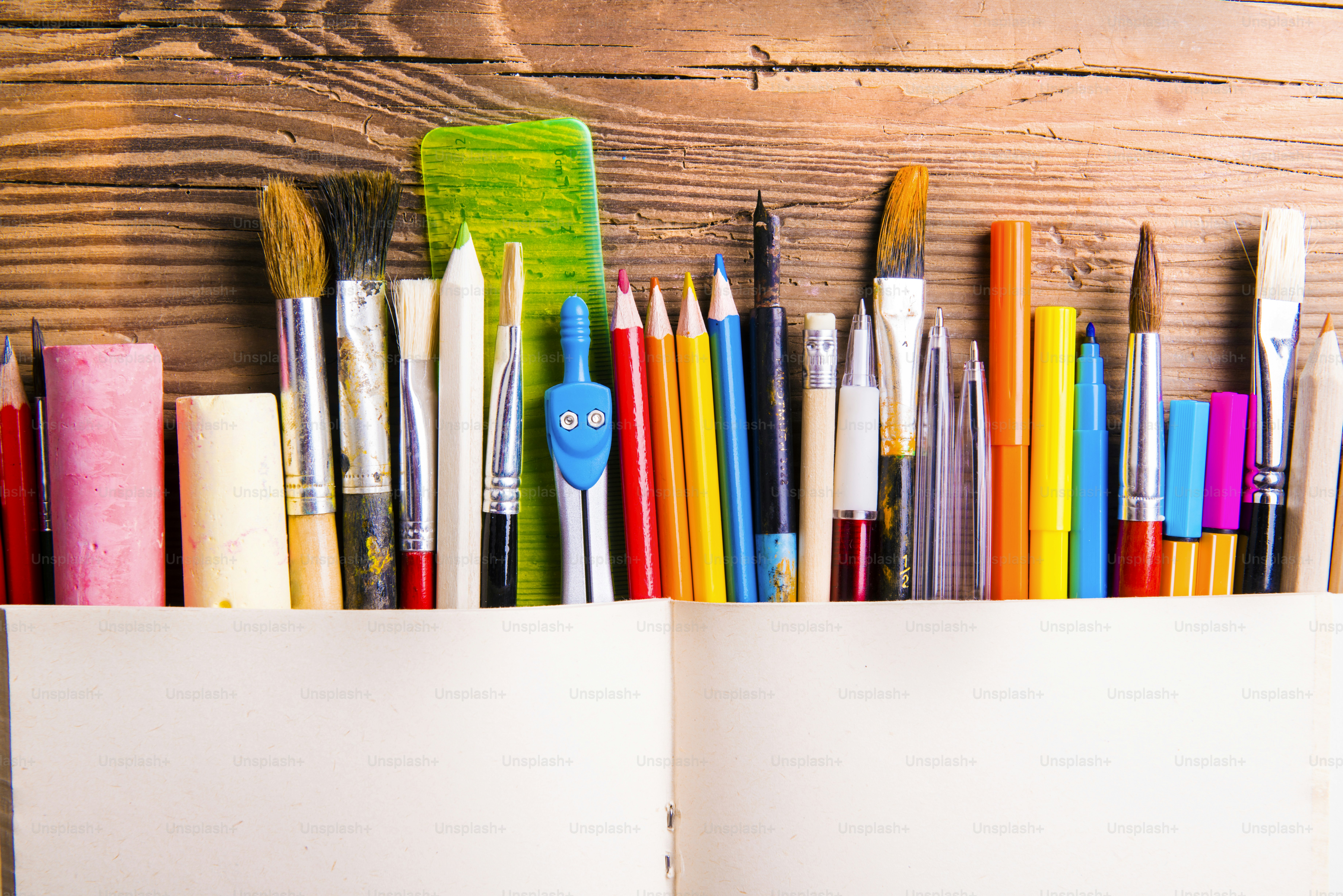 Desk with stationary. Studio shot on wooden background. photo Back to
