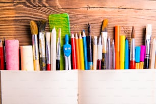 Desk with stationary. Studio shot on wooden background.