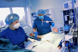 a man laying in a hospital bed next to a woman