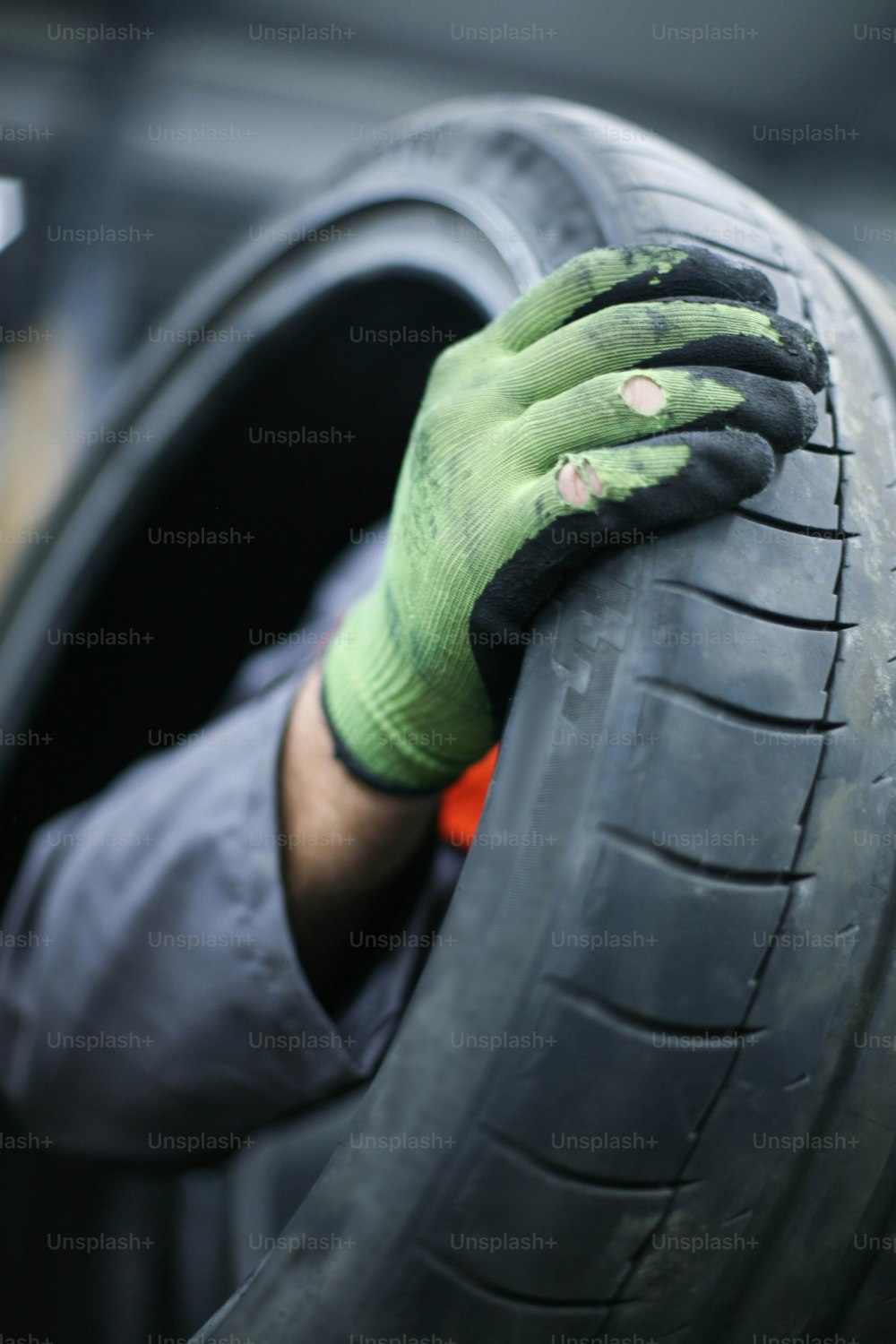 Mechanic working in auto repair shop. Focus on hand.