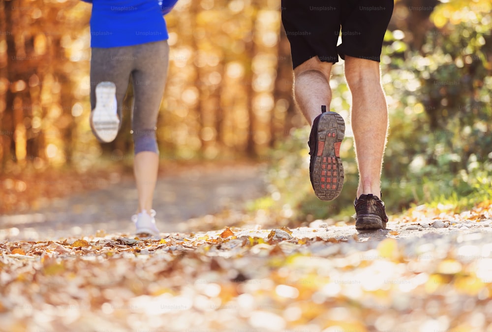 Beautiful couple running outside in autumn nature