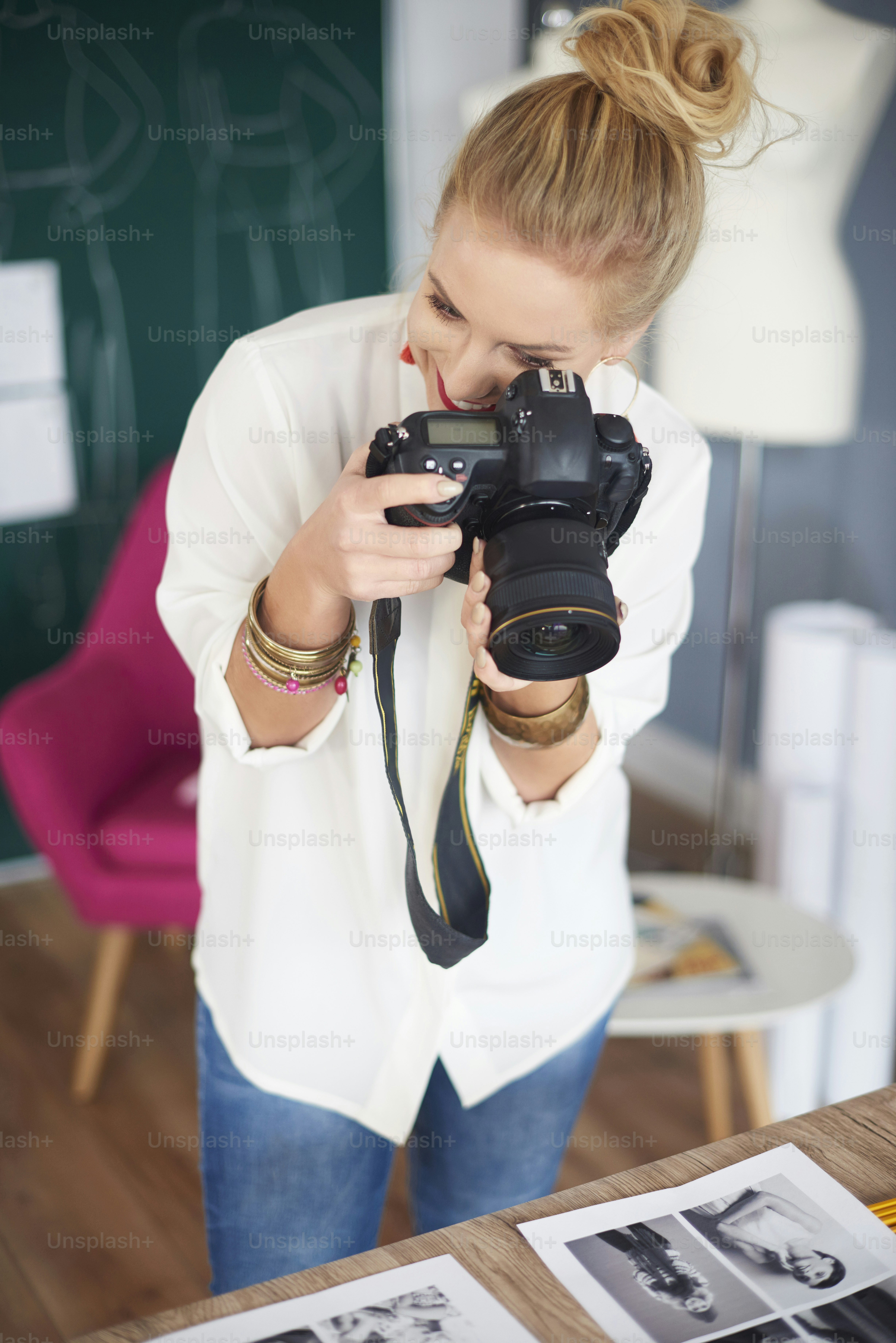 Woman photographing printout projects on the table