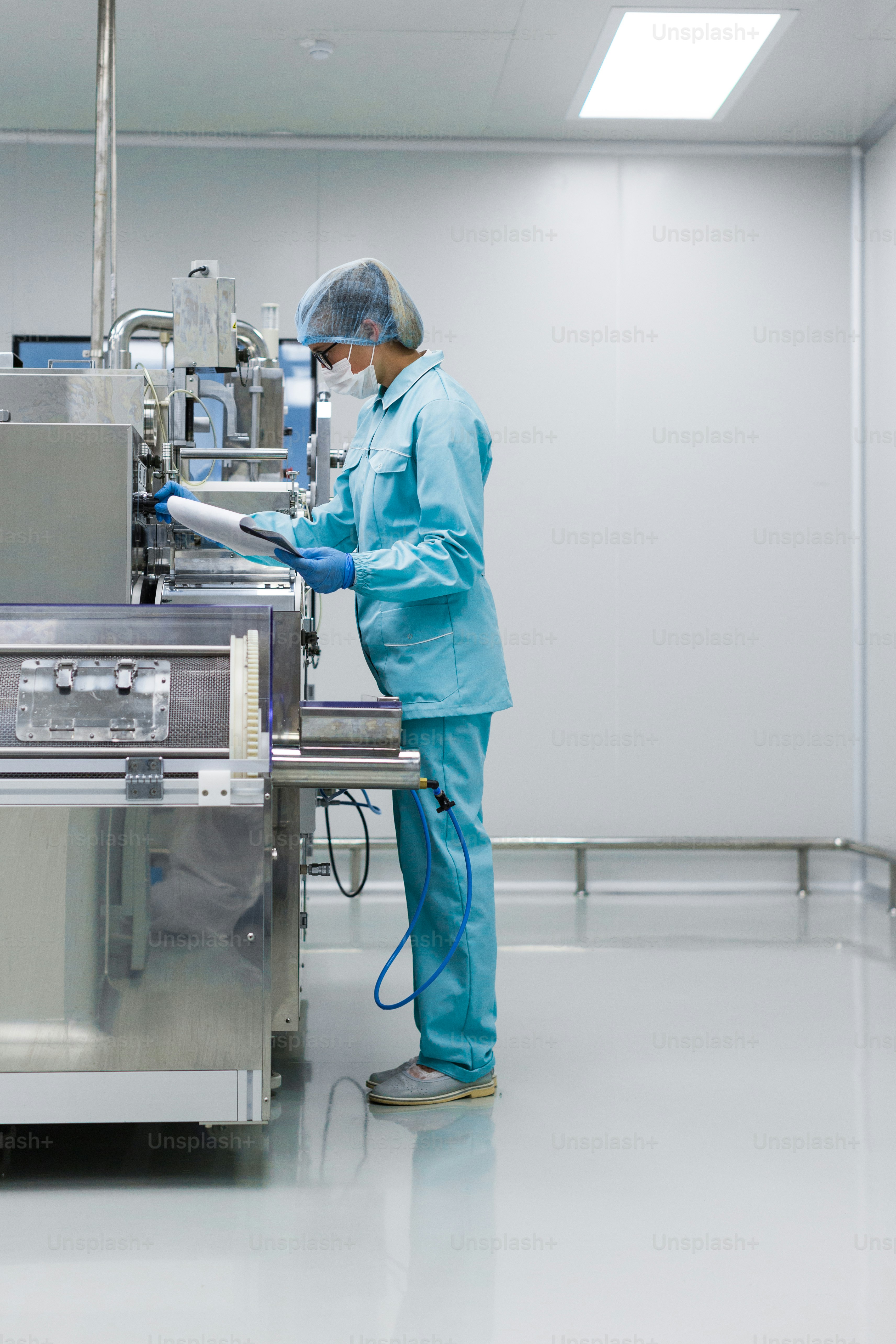 scientist in med suit working with machine