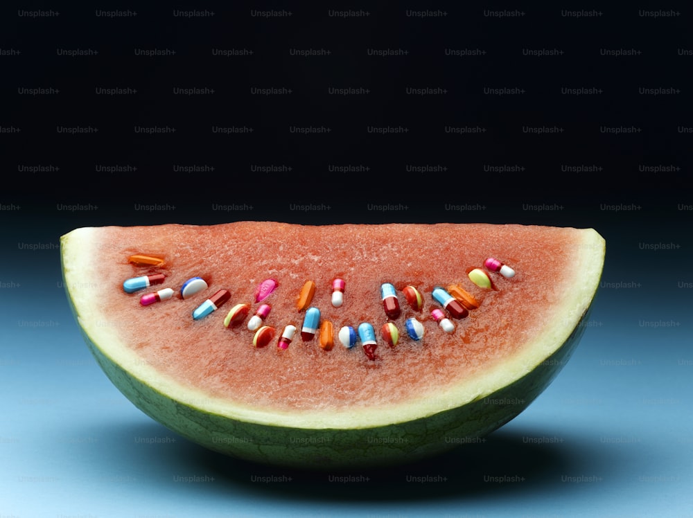 a slice of watermelon with pills on it