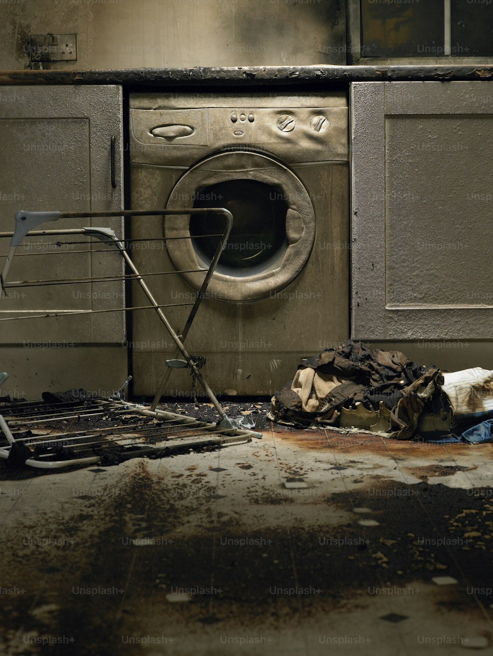 a dirty kitchen with a dirty washing machine